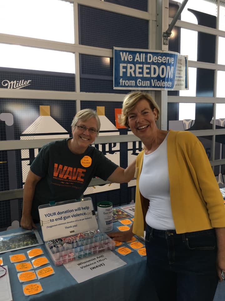 Congresswoman Tammy Baldwin and WAVE employee Kristina pose together at the WAVE information table