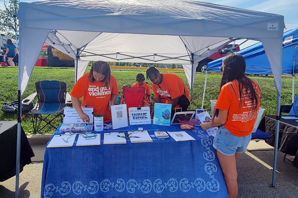 Youth tabling under a canopy