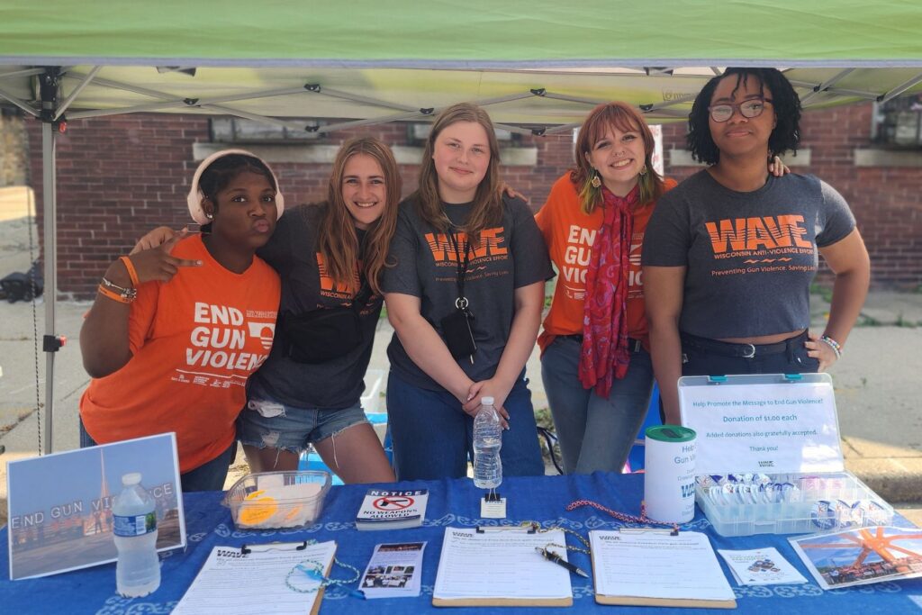 Five Youth Summer Interns pose for a picture as they table at an event, summer 2024